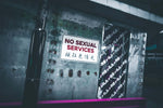 a no sexual services sign is posted on a wall