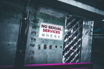 a no sexual services sign is posted on a wall