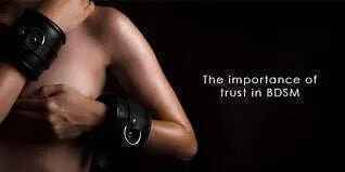 BDSM trust importance with leather cuffs on bare skin.