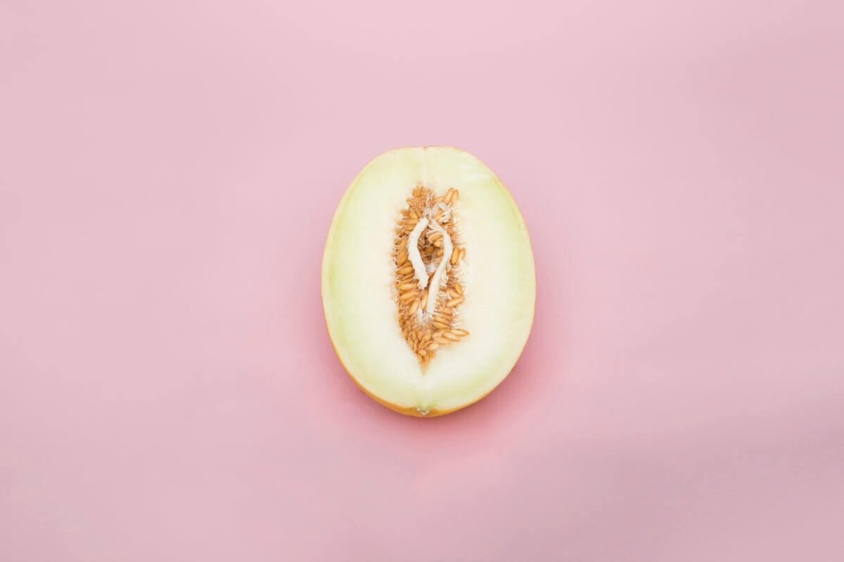 Half melon on pink background symbolizing exploration in "Exploring Sensual Freedom with the Leg Open Restraints Set: A Comprehensive Guide."