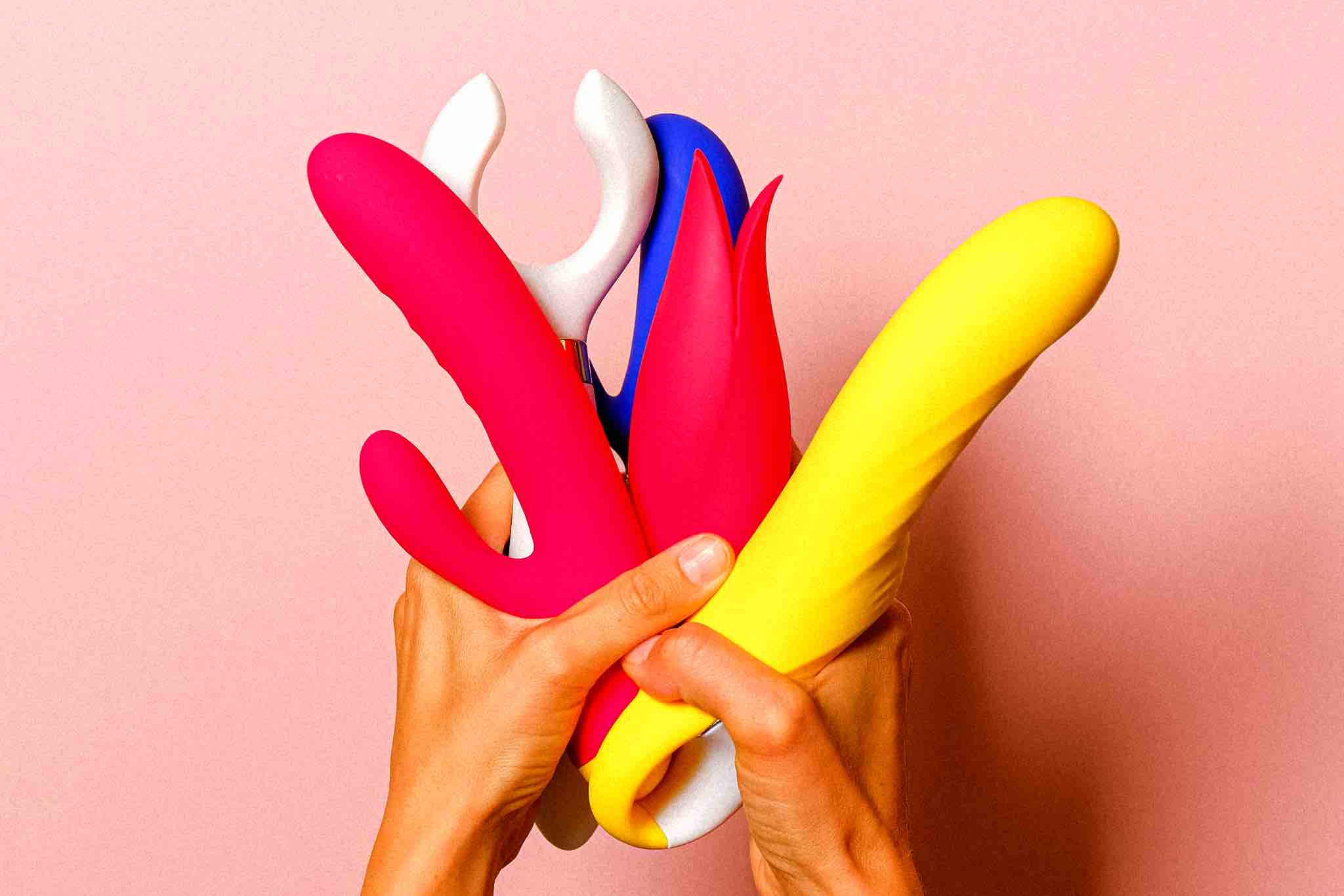 Hands holding colorful sex toys, illustrating myths and truths about sex toys.