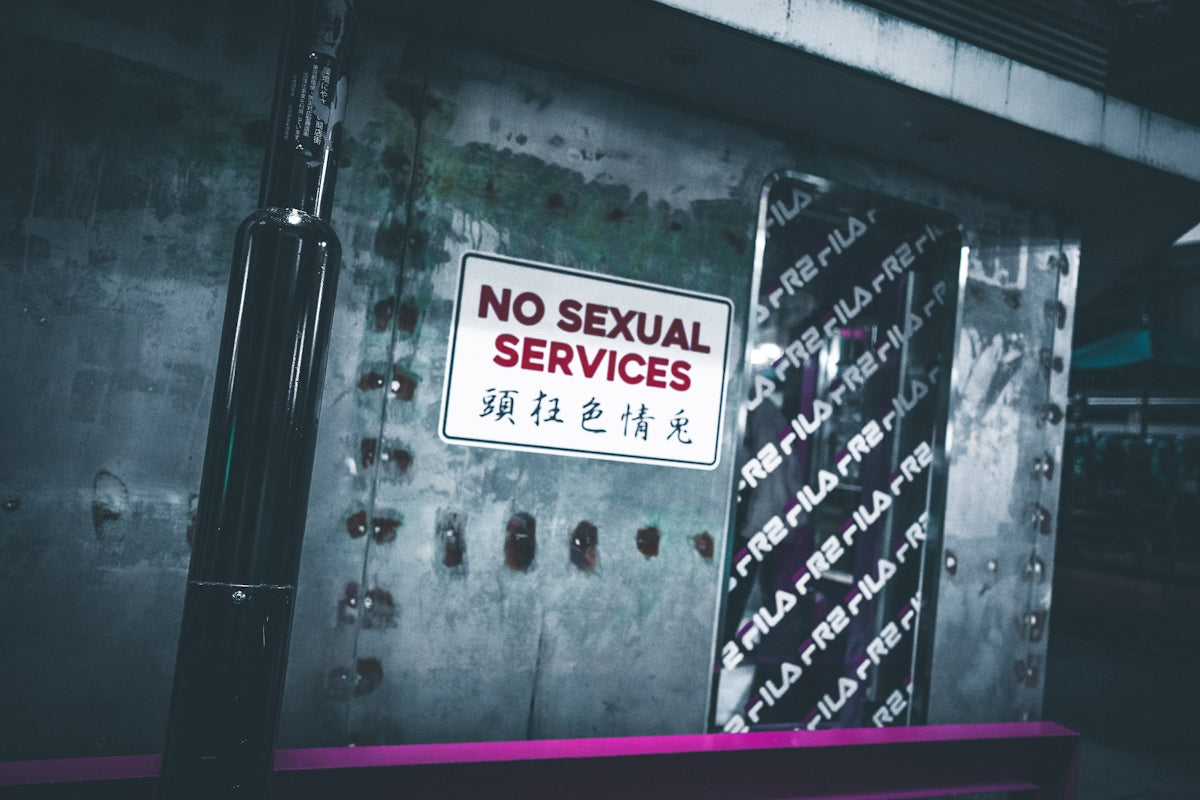 a no sexual services sign is posted on a wall