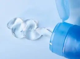 Why lubricants make a difference: close-up of lubricant being dispensed from a blue bottle on a light surface.