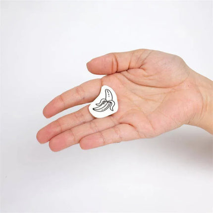 Hand holding a design from the 10 temporary Tattoos Candy Collection, showing a fun candy motif on a white background.