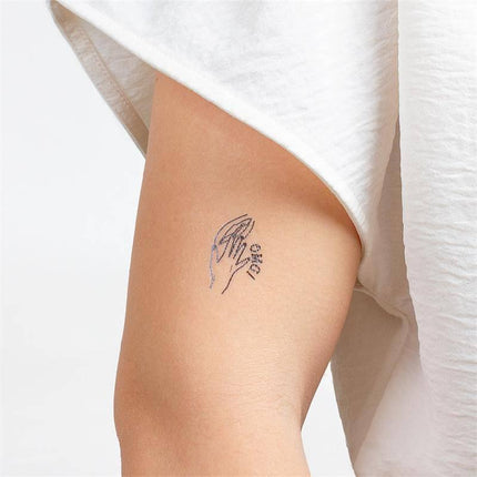 Arm adorned with a design from the 10 temporary tattoos Kinky Collection, featuring a bold and flirtatious motif.