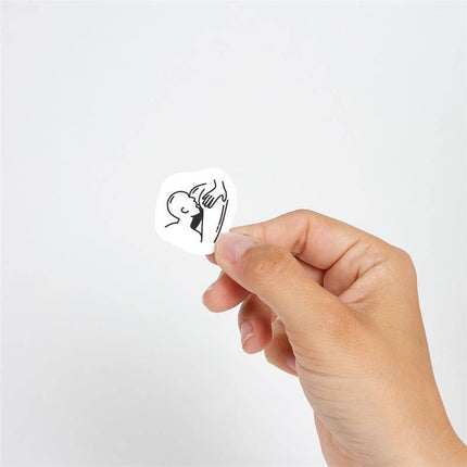 Hand holding one of the 10 temporary tattoos Kinky Collection from Chic Tattoo, featuring a provocative design.