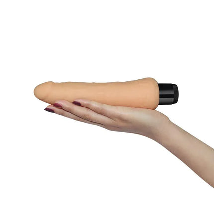 Vibe Real Feel 8 Flesh vibrator held in hand, showcasing its lifelike texture and phthalate-free cybernetic skin for realistic experience.