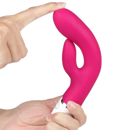 Vibe Dreamer USB Rose Red silicone vibrator held in hand, showcasing dual-motor design and sleek finish for tailored pleasure sessions.