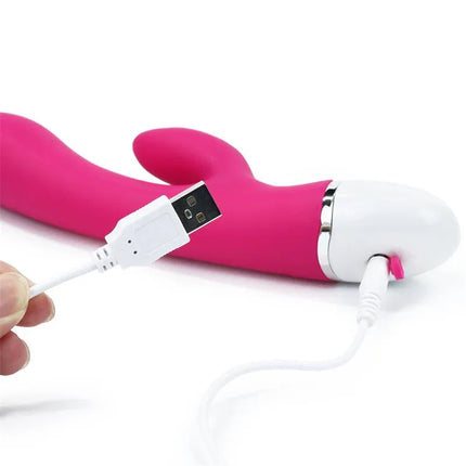 Vibe Dreamer USB Rose Red vibrator with rechargeable silicone design and dual motors for powerful pleasure, shown with USB cable.