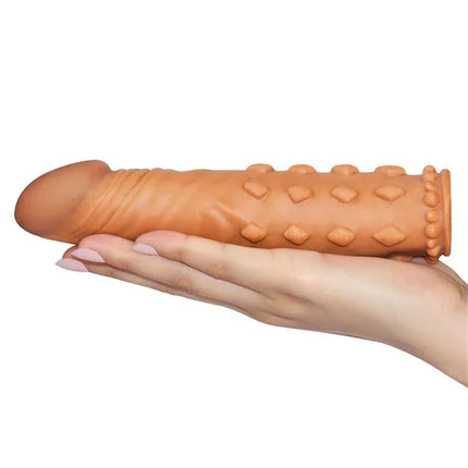 Penis Sleeve Add 2 Pleasure X Tender Brown in hand for enhanced sensation and realism