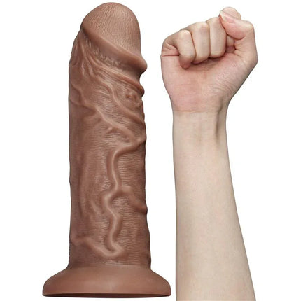 Dildo King 10.5 with Vibration Chubby Brown beside a clenched hand for size comparison, featuring lifelike design and texture.