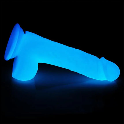 Dildo Lumino Play 8.0 glowing blue in dark setting, showcasing realistic texture and ergonomic shape.