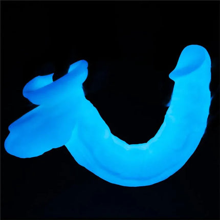 Dildo Lumino Play 10.5 glow-in-the-dark pleasure tool illuminating in visible blue light with safe, non-toxic glitter.