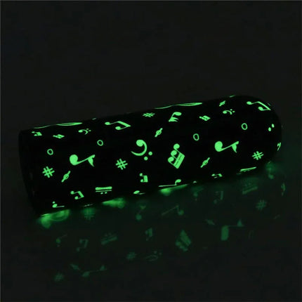 Vibrating Bullet Glow-in-the-dark with musical notes design, compact and travel-friendly pleasure device, glow finish for easy locating.