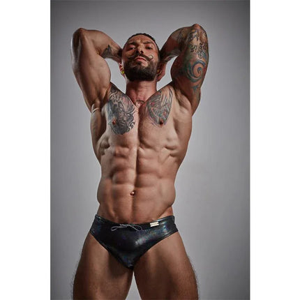 Model wearing C4M Emerald Swiwear Midnight showing modern men's swimwear with emerald accents and performance comfort fit.