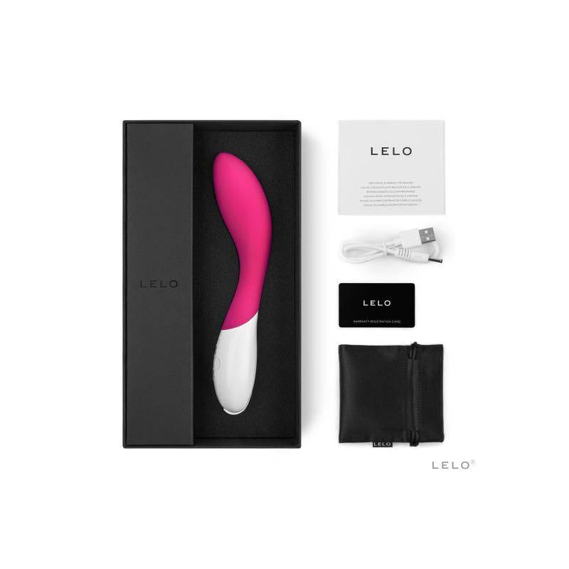 Cerise and white curved personal massager with velvet pouch, USB charger, and user manual in black box.