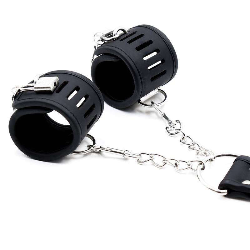 Black vegan leather handcuffs with silver metal clasps and adjustable straps connected by a chain.