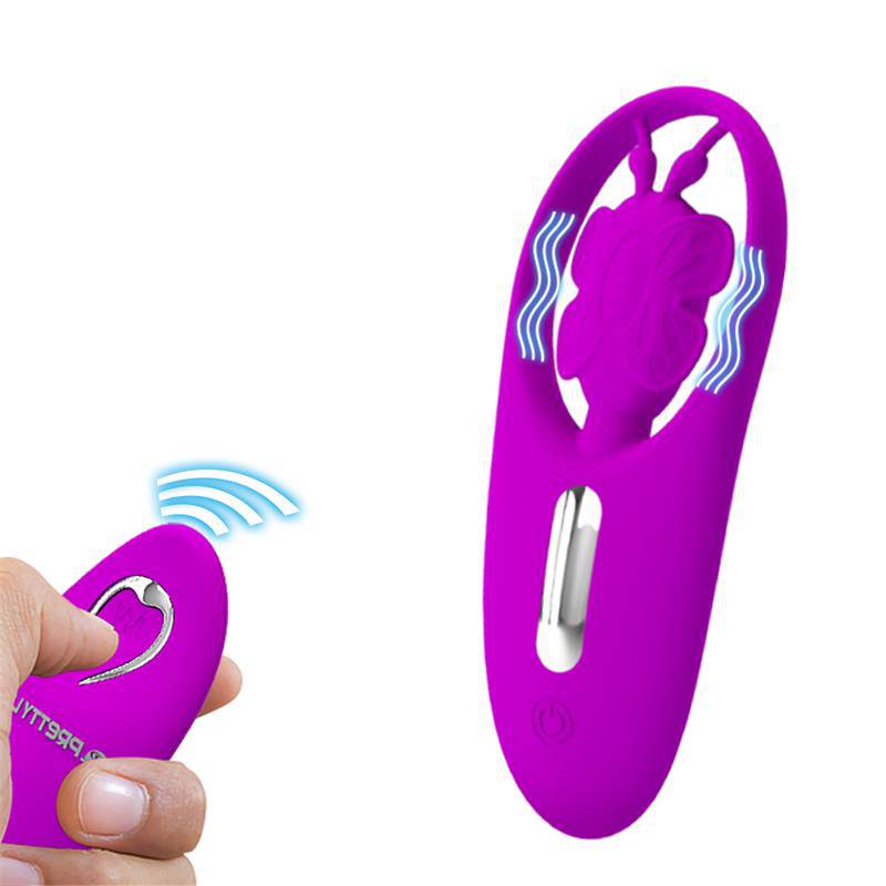 Purple butterfly-shaped panty stimulator with silver control button and wireless remote in hand.