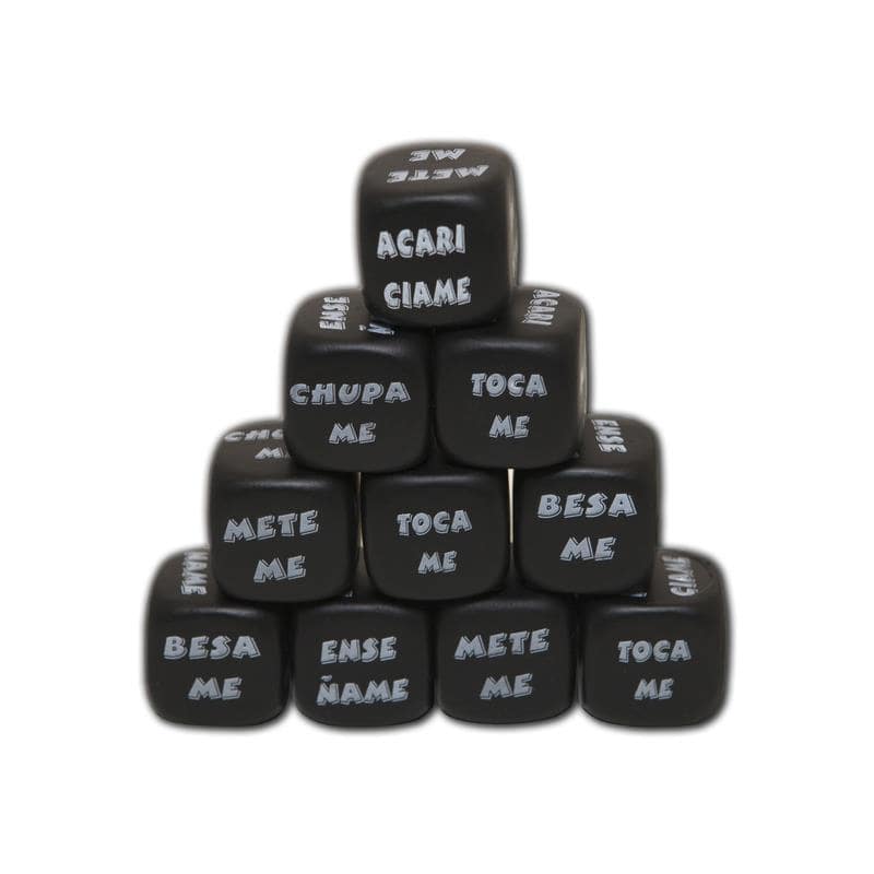 Stacked black dice with white Spanish phrases like "Toca Me," "Besa Me," and "Chupa Me" on each face.