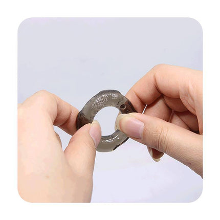 Hands holding an elastic ring from the 3 Set Cock Ring collection for customizable fit and extended stamina support.