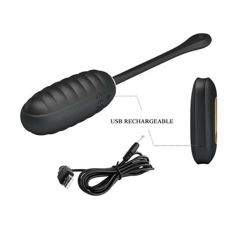Black ribbed kegel ball with elongated tail, wireless remote, and USB charging cable.