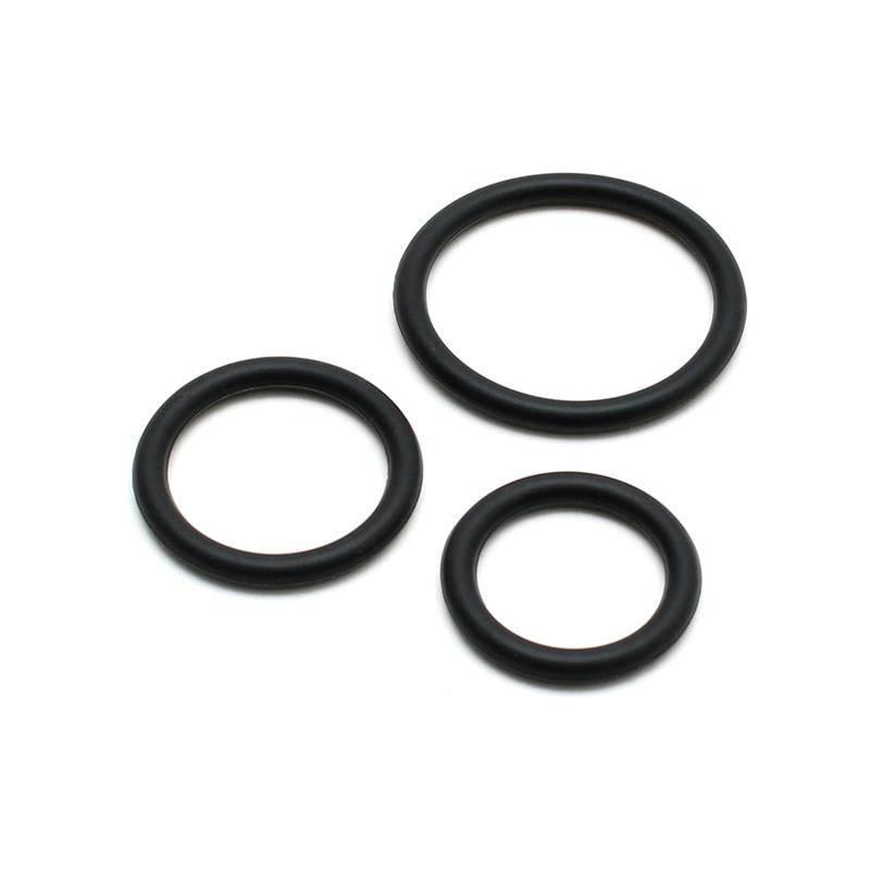 Set of three black silicone penis rings in varying sizes on white background.