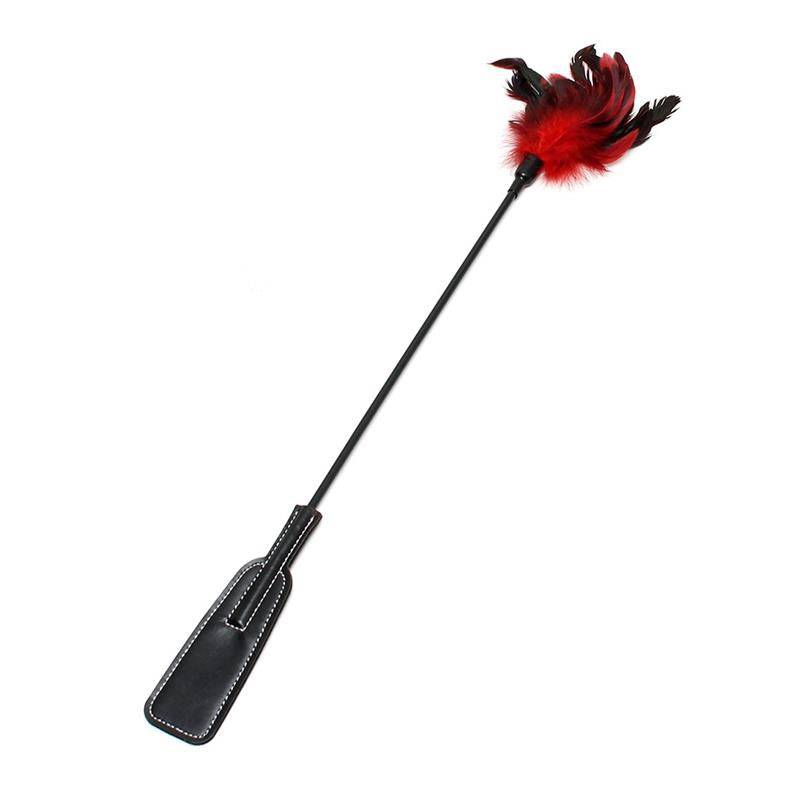 Black leather whip with long handle and red and black feathered tip.