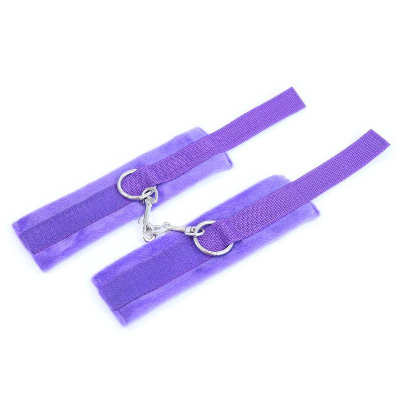 Purple velcro handcuffs with long soft fur lining and metal D-ring attachments.