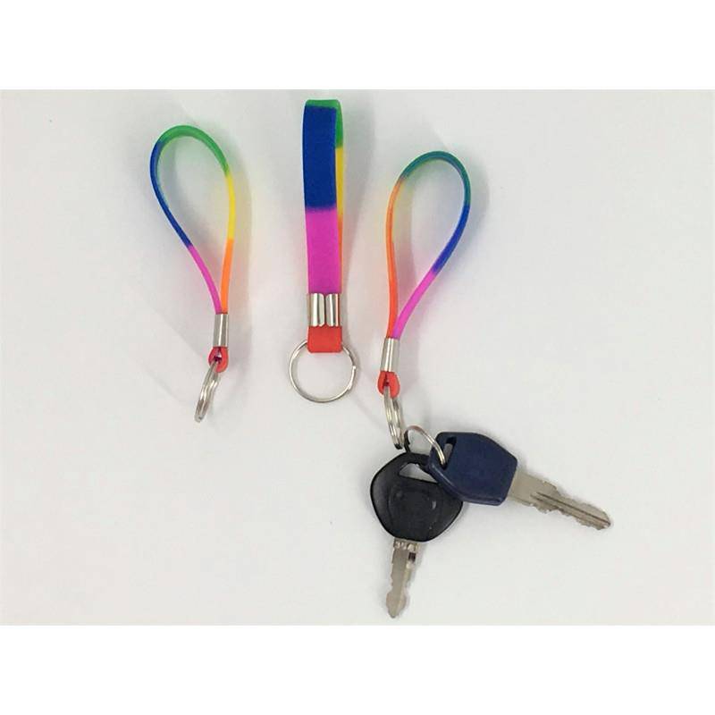 Rainbow silicone keychains with metal clasp and keyring attachment, one holding two keys.