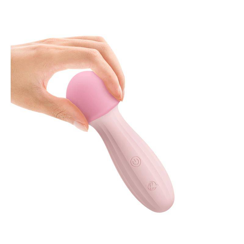 Pink silicone mushroom-shaped USB rechargeable massager held by hand with button controls.