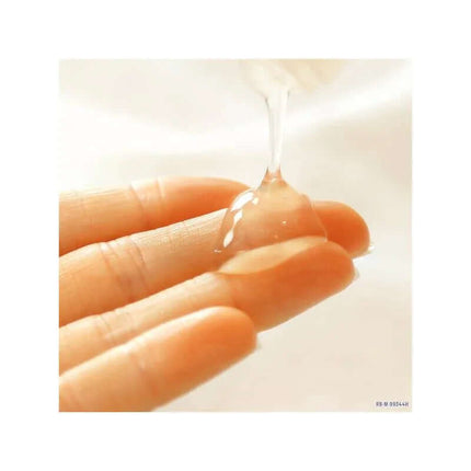 Natural Intimate Moisturizing Lubricant 100 ml being applied to fingers for a smooth and hydrating experience with 100% natural ingredients.