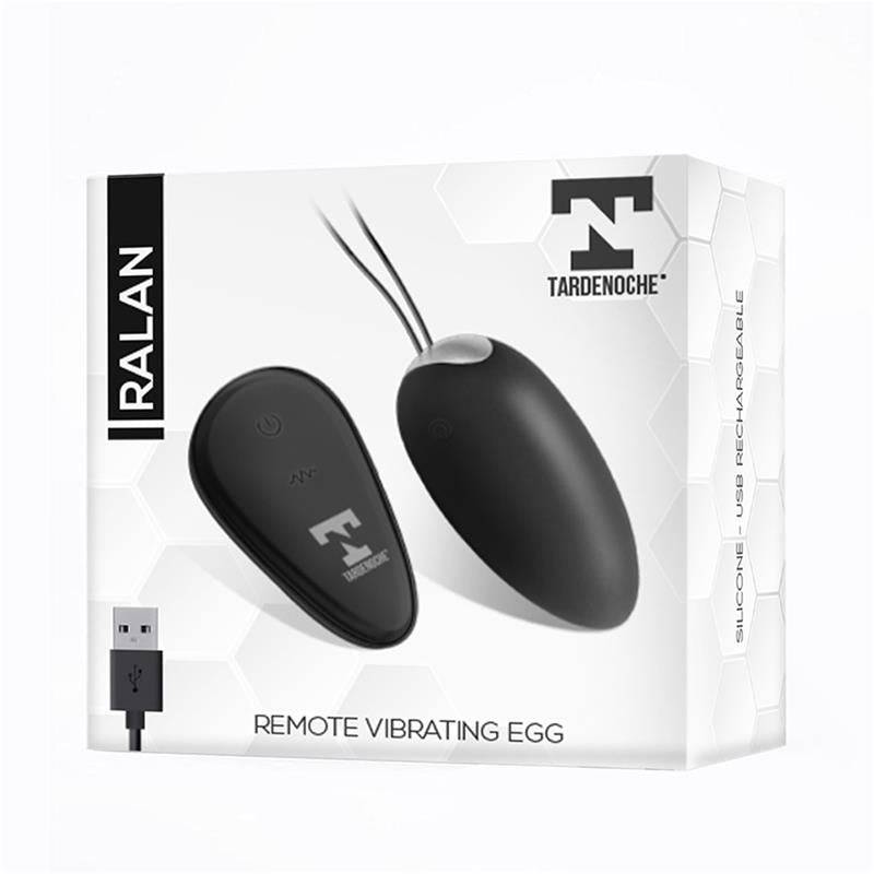 Black oval vibrating egg and matching remote control with magnetic USB charger on white packaging box.
