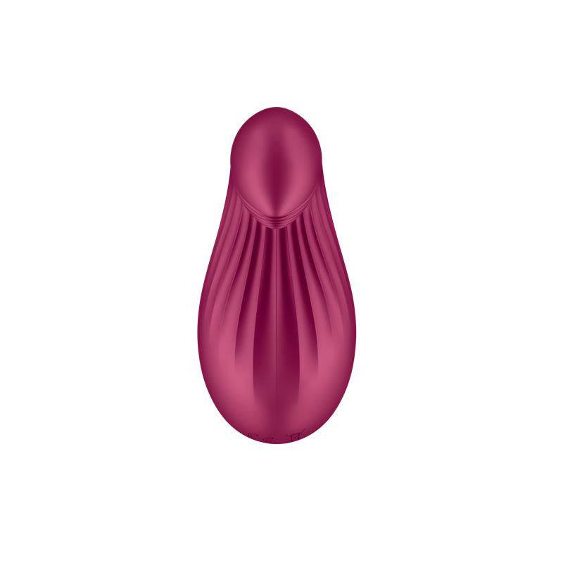 Berry-colored silicone personal massager with textured grooves and ergonomic shape.