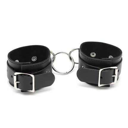 Cuffs Adjustable leather bondage cuffs with black finish and secure buckles for comfortable and stylish restraint.