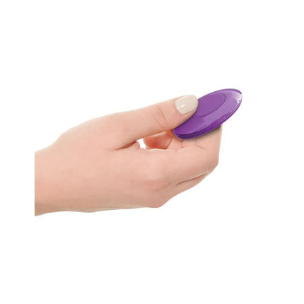 Magnetic remote control for Butt Plug with Vibration with a sleek purple design held in a hand, enhancing ease of use and customization.