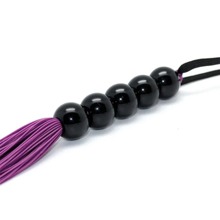 Flogger 38 cm purple silicone handle, designed for sensation-rich impact play in BDSM sessions.