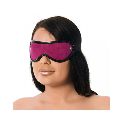 Pink and black leather blindfold on model, perfect for sensory play and BDSM exploration. Comfortable one-size fit with elastic strap.