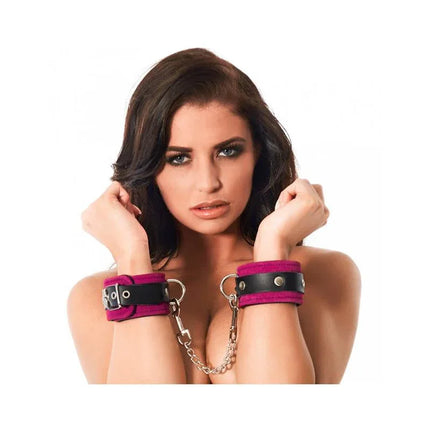 Woman wearing Hand cuffs-Adjustable in black leather with pink suede interior for BDSM play