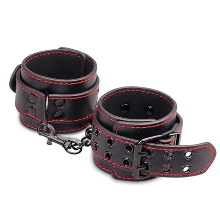 Handcuffs Bondage Black made from faux leather with red stitching, adjustable for comfort and style in intimate play restraint.