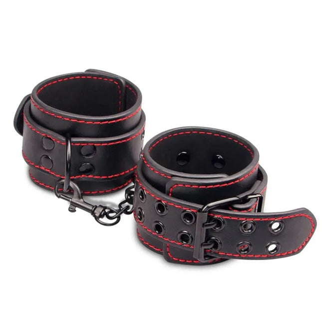 Handcuffs Bondage Black made from faux leather with red stitching, adjustable for comfort and style in intimate play restraint.