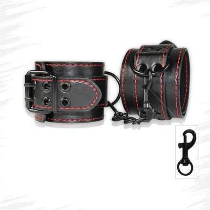 Handcuffs Bondage Black made of black faux leather with red stitching and adjustable straps for intimate play.