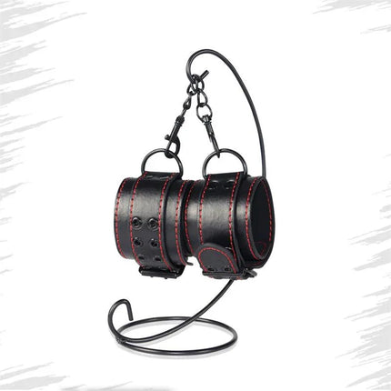 Handcuffs Bondage Black faux leather adjustable restraints with black color for intimate play on a display stand.
