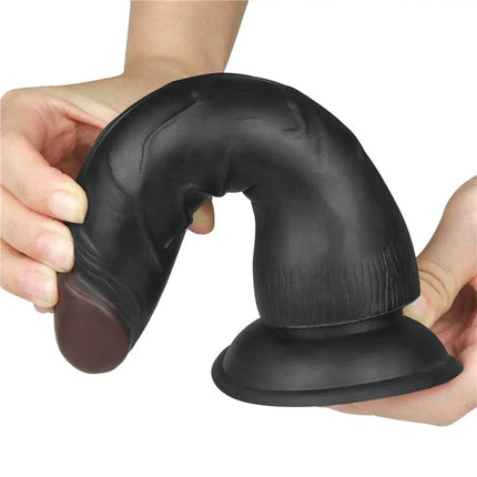 Realistic black silicone dildo with suction base held in hands, designed for comfort and versatility in solo or couples play.