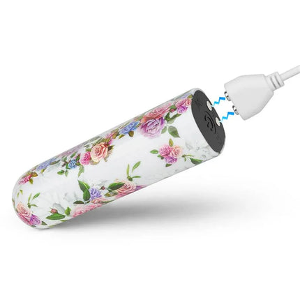 Vibrating Bullet Aphrodite with floral design being charged via USB, showcasing its compact and discreet travel-friendly features.