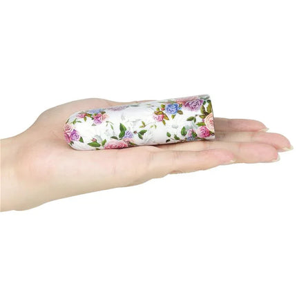 Vibrating Bullet Aphrodite held in hand, showing compact and floral design for travel-friendly pleasure.