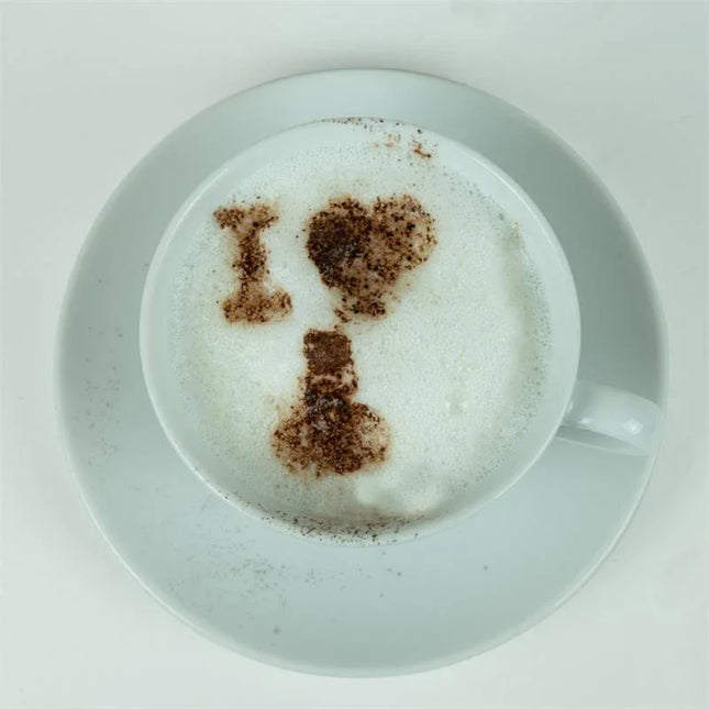 Cappuccino with cheeky design using Pack of 12 Offensive Stencils for playful coffee art decoration.