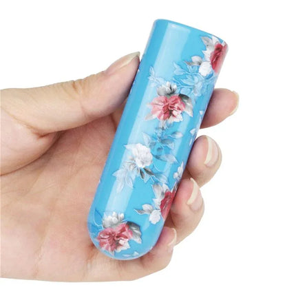 Compact Vibrating Bullet Daphne with floral pattern held in hand; features 10 vibration functions; discreet and travel-friendly design.