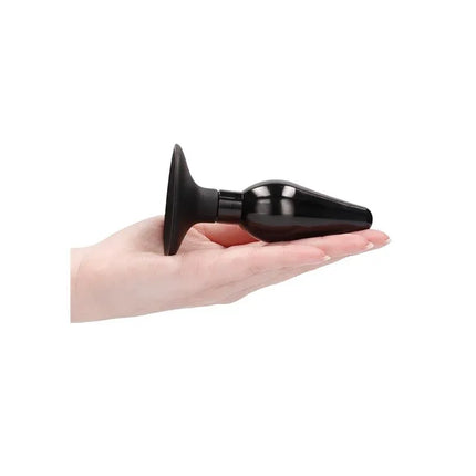 Butt Plug Set Pointed Large Suction Cup Black in hand, highlighting size and ergonomic design for precise control and thrilling stimulation.