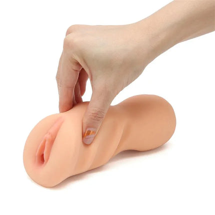 Hand holding Dan Elle Realistic Male Masturbator Vagina showcasing texture and ergonomic design.