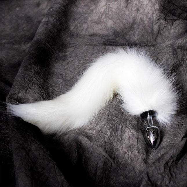 Metal Butt Plug with Foxy Tail Velvet Touch 40 cm White on a dark fabric background